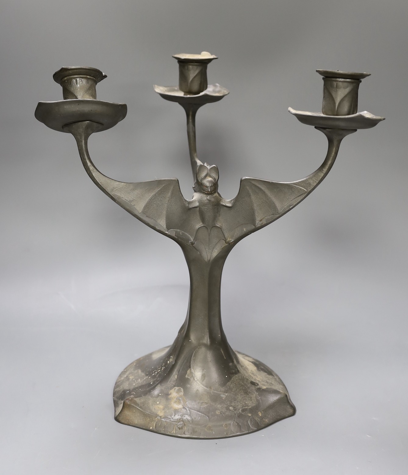 A Kayserzinn pewter three branch 'bat wing' candelabrum, 30cm tall